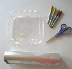 the supplies needed to make this craft include scissors, markers, and plastic wrappers