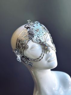 Step into the realm of goddesses with our women's masquerade mask in silver. Rhinestones delicately embellish the mask, adding a touch of sparkle. Silver chains gracefully adorn the mask, creating an enchanting movement. Capture attention at any masquerade party, ball, or themed event!


Age Group/Gender - Adult/Women

Size/Type - One size fits all adults

Mask Color - Silver

Mask Material - Laser Cut Metal

Special Features - Chains and rhinestones Fantasy Ball, Mask Full Face, Silver Mask, Chain Mask, Metal Mask, Prom 2024, Spring 2025, Laser Cut Metal, Silver Chains