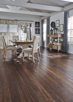 a dining room with wooden floors and white walls