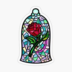 a stained glass window with a red rose in it