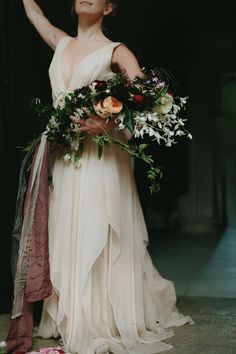 a woman in a white dress holding flowers