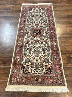 an antique persian rug is laying on the wooden floor in front of a wood floor