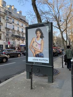 a billboard on the side of a street with a photo of a woman in it