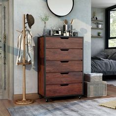 a room with a dresser, mirror and other items on the wall next to it