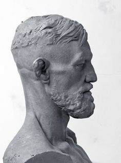 a black and white photo of a statue of a man's head with his eyes closed