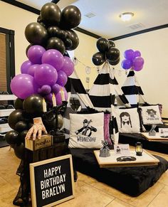 a birthday party with black and white balloons