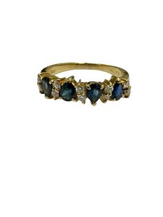 a gold ring with three blue stones on the front and two white diamonds on the back