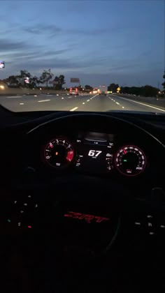 the dashboard of a car on a highway at night