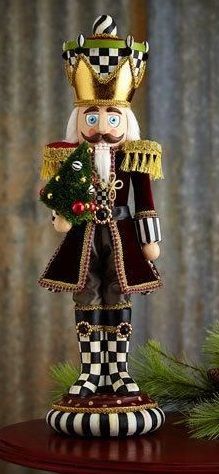 a nutcracker figurine holding a christmas tree