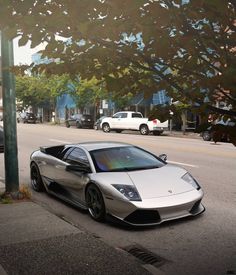 a silver sports car is parked on the street