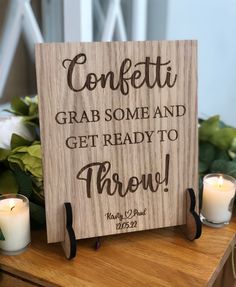 a wooden sign that says confetti grab some and get ready to throw with candles