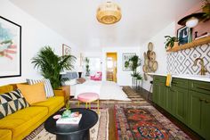 a living room filled with lots of furniture and decor on top of carpeted flooring