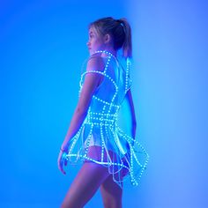 a young woman in a neon dress is posing for the camera