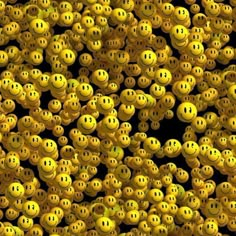 many yellow smiley faces are grouped together in this photo, and the background is black