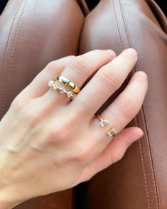 a woman's hand with two rings on her fingers