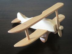 a toy airplane sitting on top of a wooden table