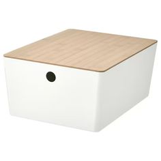 a white box with a wooden lid and black dots on the bottom is shown in front of a white background