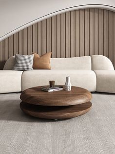 a modern living room with white couches and wood accents on the walls, along with a circular coffee table