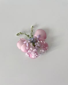 pink and white flowers sitting on top of a table