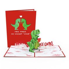 a pop up card with a dinosaur holding a heart