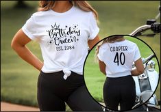 two women wearing matching shirts with the number forty birthday queen on them, standing next to a motorcycle