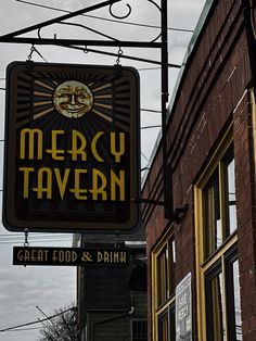 there is a sign that says merry tavern on the side of the building in front of it