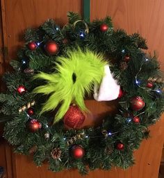 the grinch wreath has been decorated with christmas ornaments