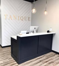 an empty reception desk in front of a tanquee sign