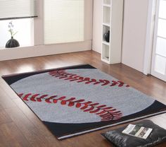 a baseball rug is on the floor in a room with hardwood floors and white walls