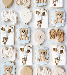 cookies decorated with teddy bears and balloons are arranged on a marble countertop for a baby's first birthday