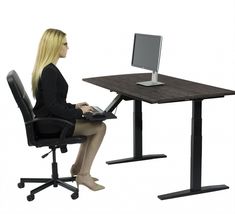 a woman sitting at a desk using a laptop computer