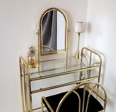 a dressing table with a mirror, stool and lamp