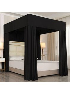 a black canopy bed with curtains on the sides