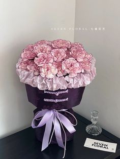 a bouquet of pink flowers sitting on top of a table