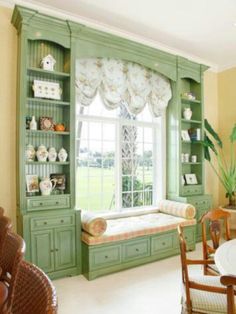 a dining room filled with lots of furniture next to a large window covered in curtains