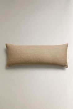 the linen pillow is hanging on the wall