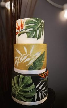 three tiered cake decorated with tropical leaves