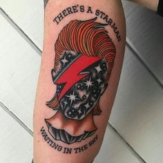 there is a tattoo on the arm of a man with a red hat and stars