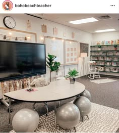 an office with exercise balls and a flat screen tv