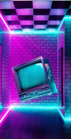 an old tv in the middle of a room with neon lights on it and a brick wall