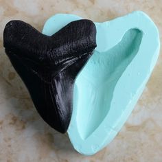 a black and blue toothbrush holder on a marble surface