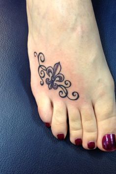 a woman's foot with a butterfly tattoo on it