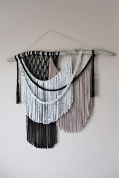 two black and white wall hangings with chains attached to the side of each one