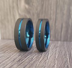 two blue rings sitting on top of a wooden table