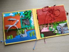 an open children's book with paper cut out of animals and farm scenes on it