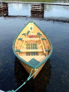 a small wooden boat tied to a dock