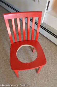 a red chair sitting in front of a door with a hole in the back seat