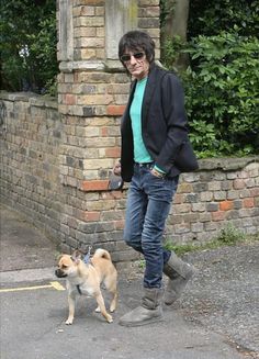 a woman standing next to a dog on a leash