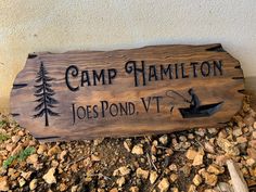 a wooden sign that says camp hamilton joe's pond vv