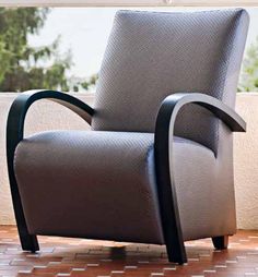 a gray chair sitting on top of a tiled floor